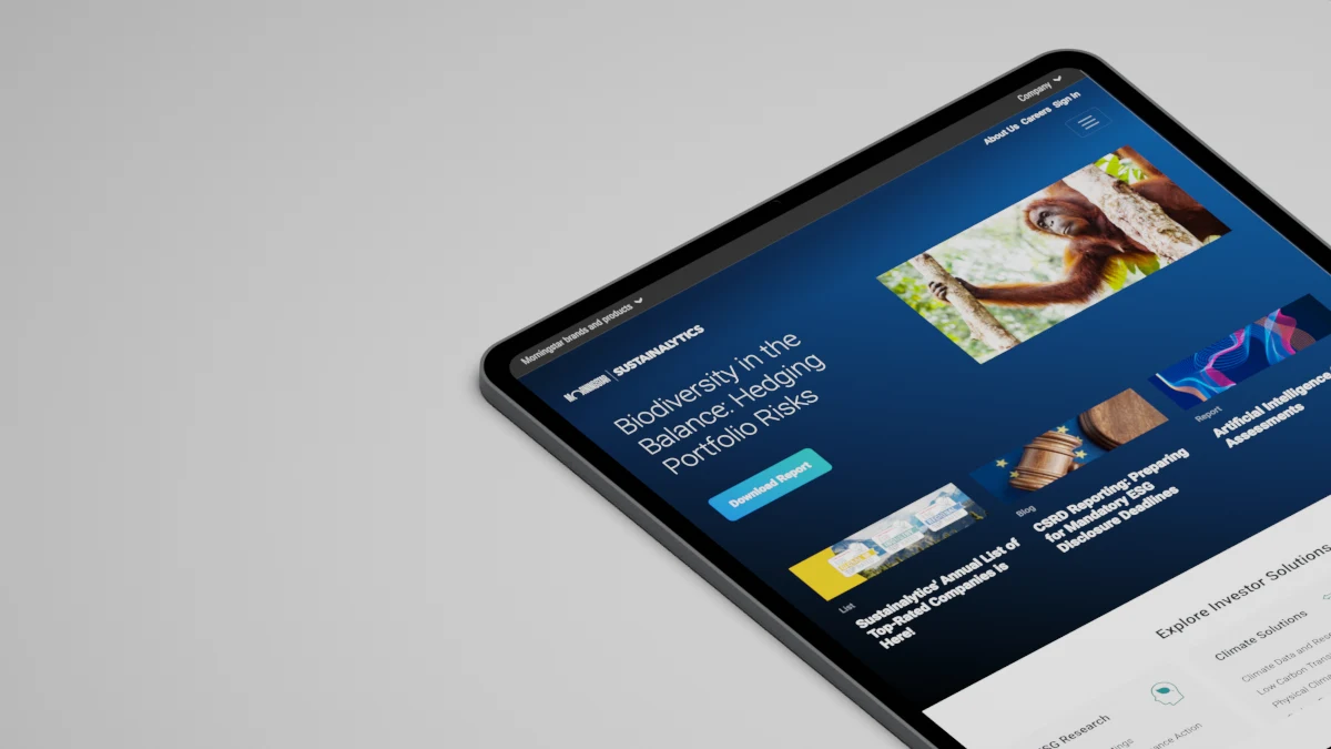 The redesigned Sustainalytics website on a tablet: a dark hero with a biodiversity feature story, a row of insight cards, and an Explore Investor Solutions section